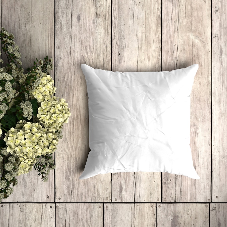 PSD modello bianco federa su una tavola di legno con decorazione floreale
