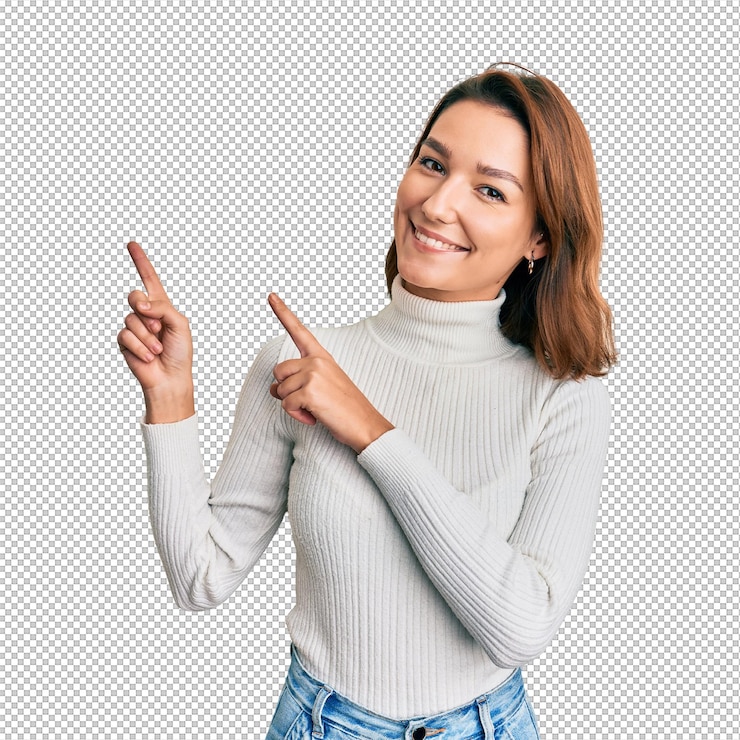 PSD mujer caucásica joven con ropa informal sonriendo y mirando a la cámara apuntando con dos manos y dedos hacia un lado