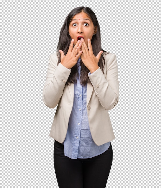 Mujer india joven del negocio sorprendida y sorprendida, mirando con los ojos abiertos