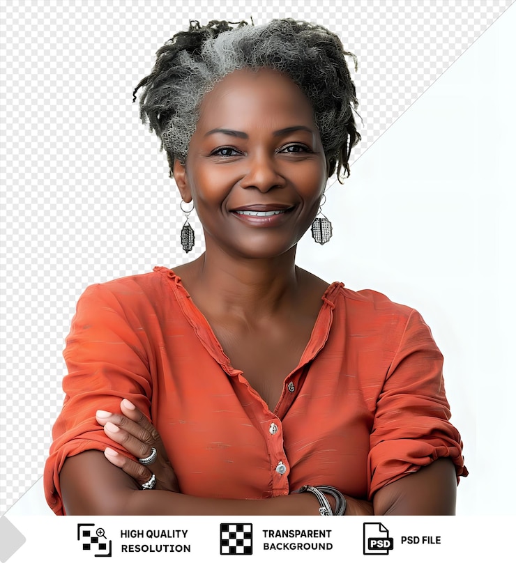 PSD mulher afro-americana de meia-idade sorrindo feliz e de pé com os braços cruzados vestindo uma camisa laranja e brincos de prata com cabelo preto e cinzento um nariz pequeno e olhos castanhos