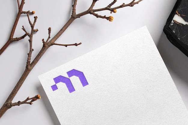 Myzora logo mockup on white paper with debossed effect v2
