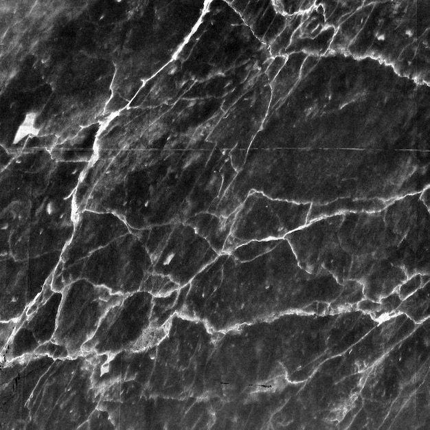 Nahaufnahme einer glatten dunkelgrauen Marmorsteinstruktur mit weißen Adern und Rissen