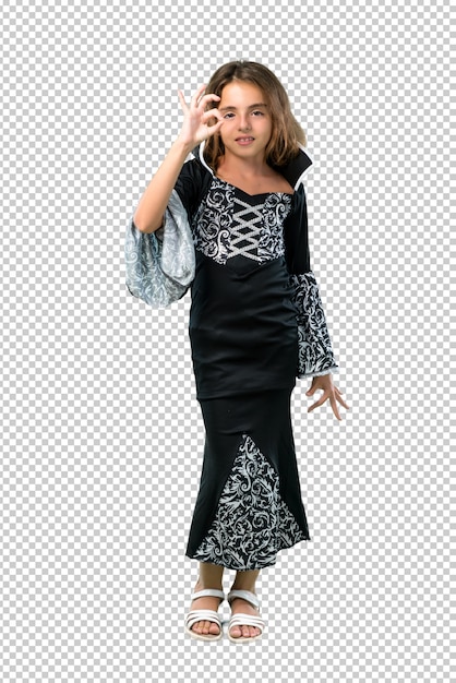 PSD niña vestida como un vampiro para las vacaciones de halloween mostrando un signo de ok con los dedos