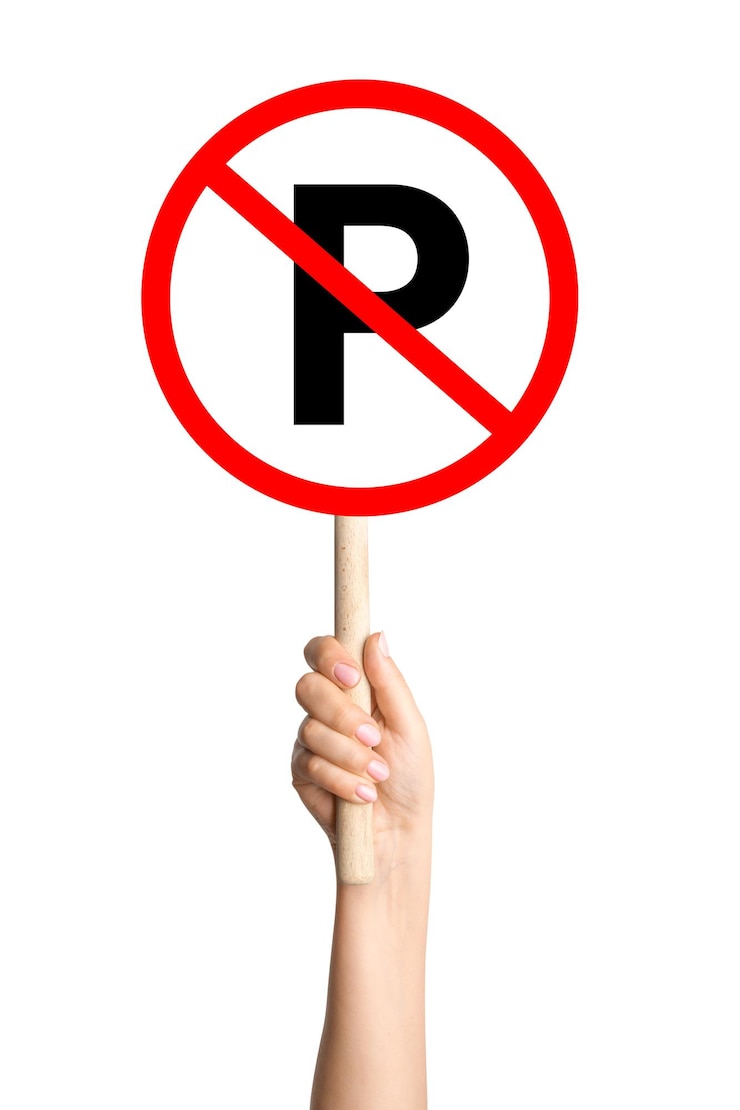 PSD no parking sign in a persons hand on a blank background great for traffic regulation road safety