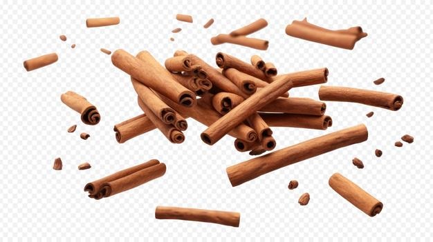 Los palillos de canela que caen aislados en un fondo transparente
