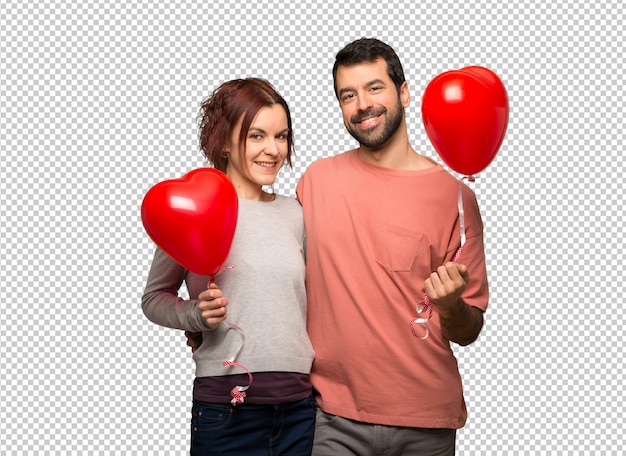 Pareja en el día de San Valentín con globos con forma de corazón