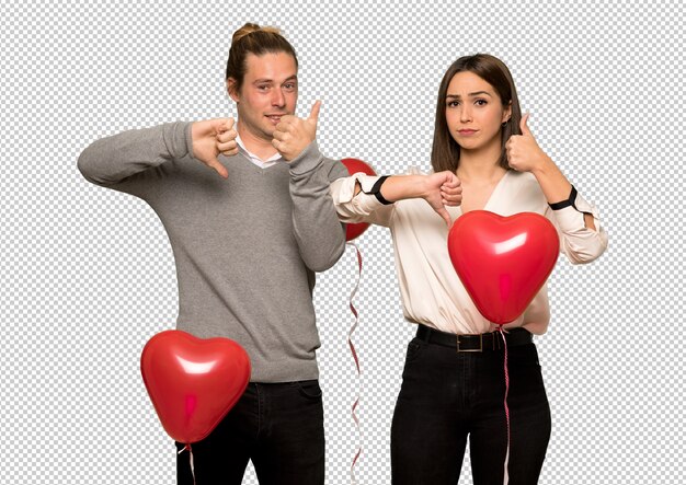 Pareja en el día de san valentín haciendo buena-mala señal. indecisa entre sí o no