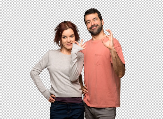 Pareja en el día de San Valentín que muestra un signo aceptable con los dedos