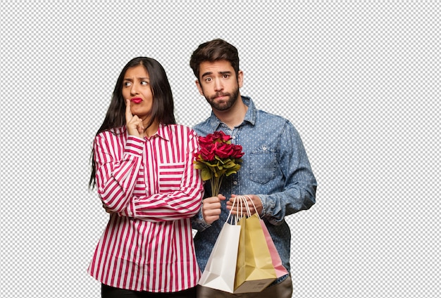 Pareja joven en día de san valentín dudando y confundida.