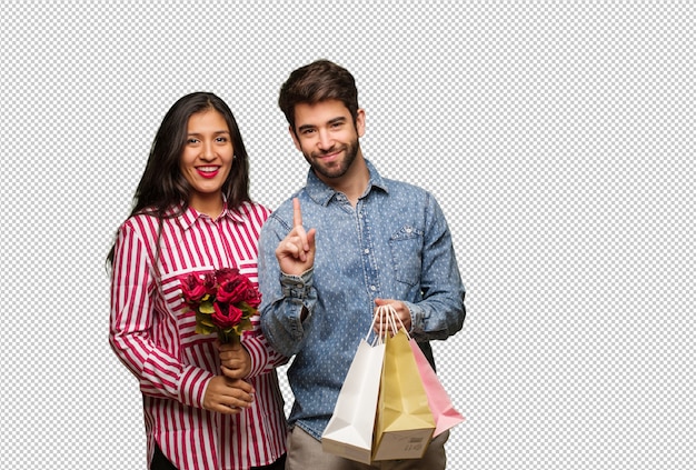 Pareja joven en el día de san valentín que muestra el número uno