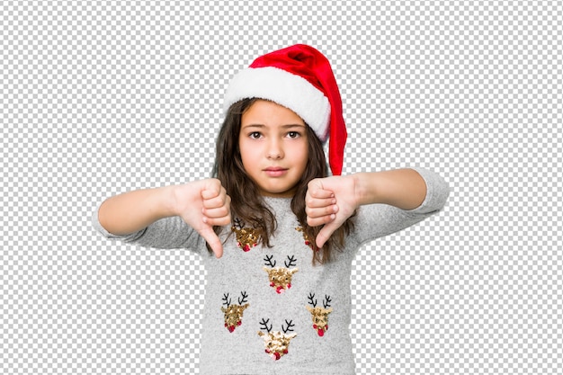 Petite Fille Fête Le Jour De Noël Montrant Le Pouce Vers Le Bas Et Exprimant L'aversion.