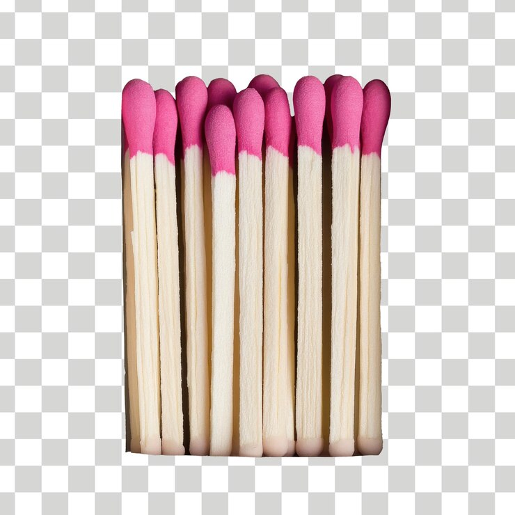 una pila de cerillas con una franja rosa en un fondo a cuadros