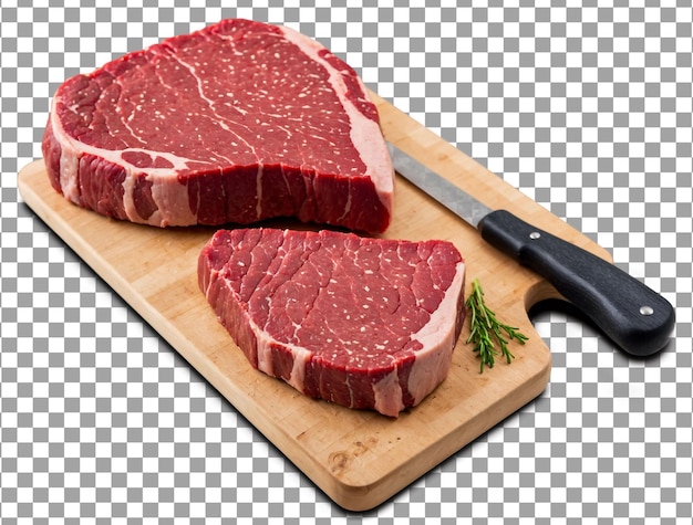 une planche à couper avec des steaks et un couteau dessus