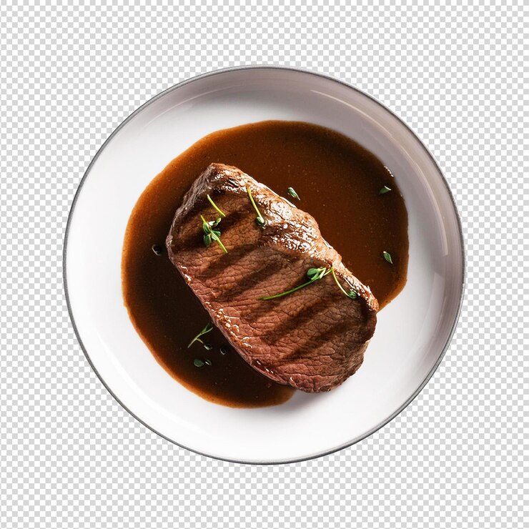 Un plato de filete y salsa con una salpicadura verde en un fondo transparente