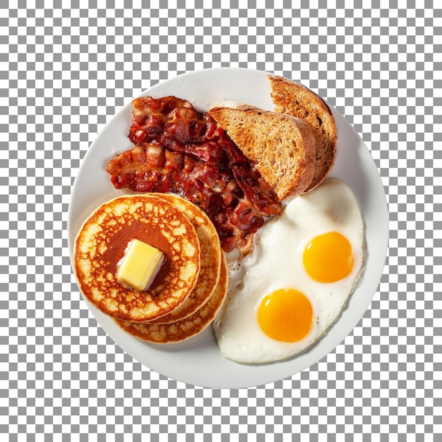 Un plato de panqueques, tocino, huevos y tocino sobre un fondo transparente.