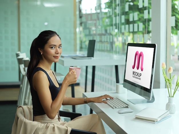 PSD portrait de femme entrepreneur à l'aide d'une maquette d'ordinateur