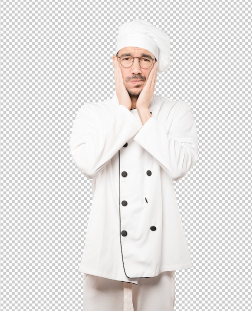Preocupado jovem chef fazendo um gesto de alívio