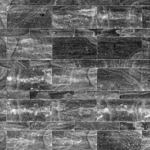Un primer plano de una pared de ladrillo de piedra gris