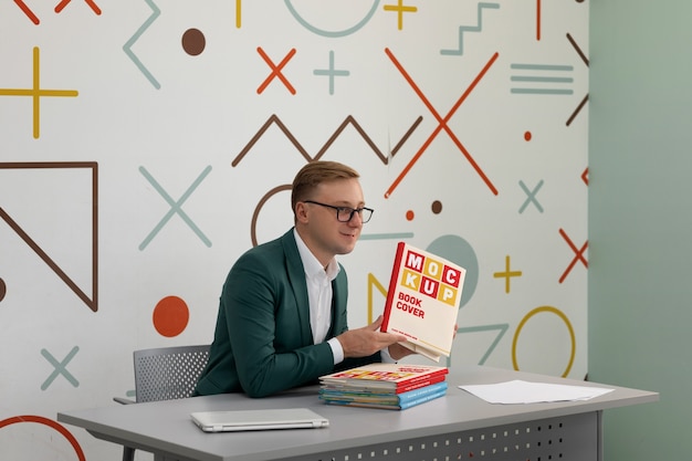 Professor hält ein modell von unterrichtsmaterialien in der hand