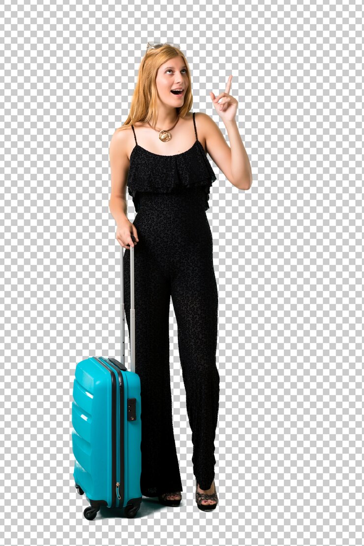 PSD ragazza bionda che viaggia con la sua valigia in piedi e pensando un&#39;idea che punta il dito verso l&#39;alto