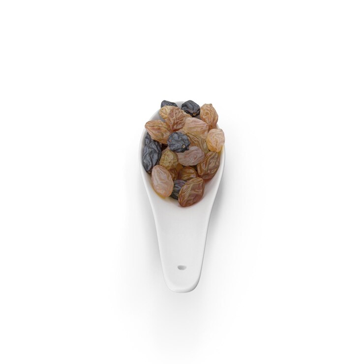 PSD raisins in a white spoon isolated on white background