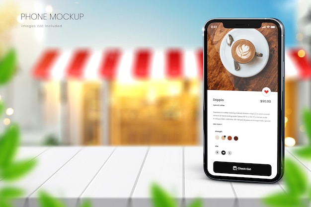 Realistisches iphone 13-modell auf verschwommenem café-hintergrund