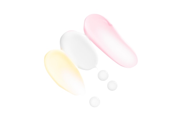Satz von kosmetischen Creme-Schmieren rosa, gelb und weiß auf einem leeren Hintergrund