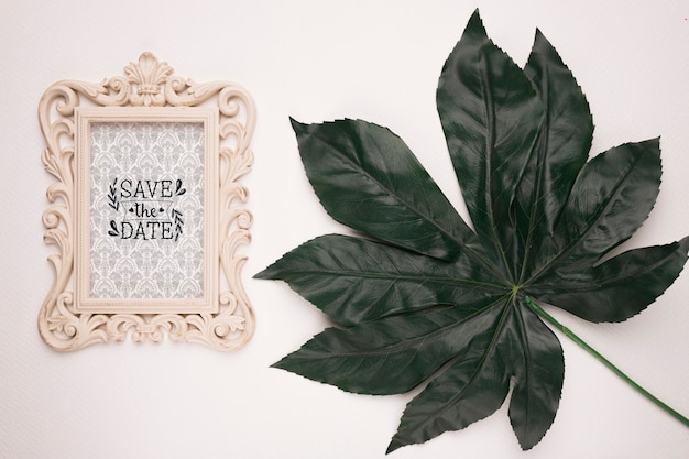 Save the date mock-up vintage frame and leaf