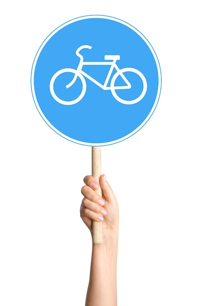 Signe de vélo dans la main d'une personne sur un fond blanc Idéal pour le transport à vélo ou