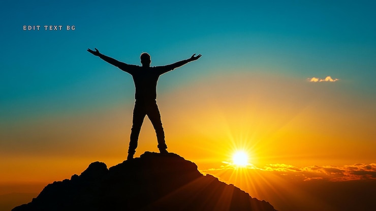 PSD silhouette of a man with arms outstretched atop a mountain peak at sunset