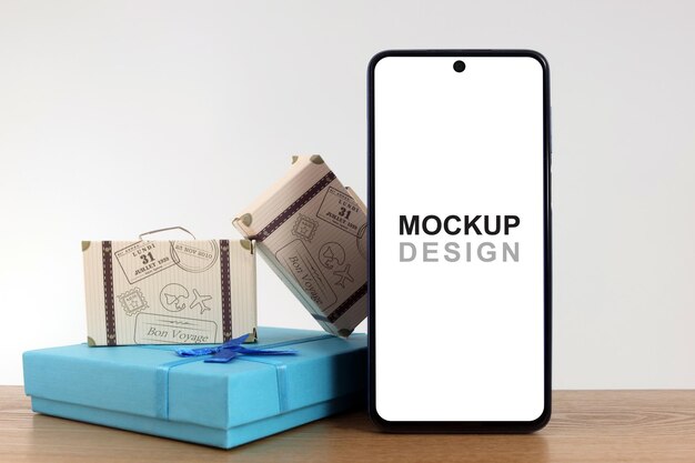 PSD smartphone mockup com malas e caixa de presente em azul