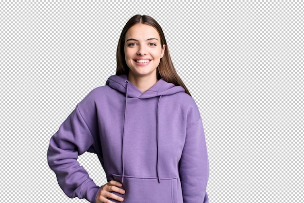 Sonriendo felizmente con una mano en la cadera y con confianza positiva actitud orgullosa y amistosa