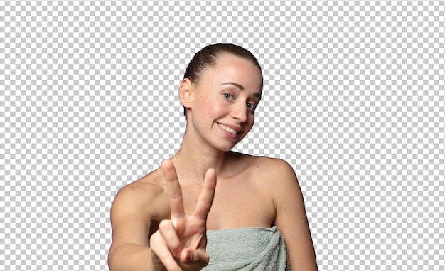 sonriendo y mirando feliz despreocupada y positiva gesticulando victoria o paz con una mano