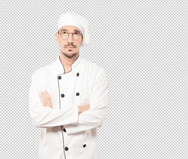 Sorprendido joven chef mirando gesto