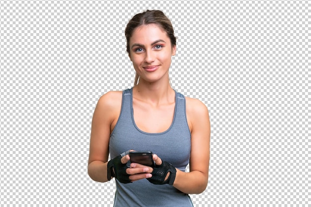 Sport schöne uruguayische Frau über isolierten Hintergrund senden eine Nachricht mit dem Handy