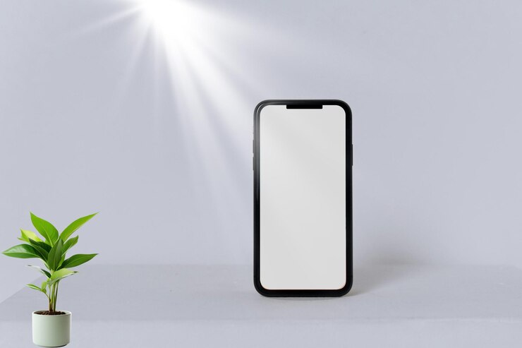 un teléfono blanco con una base negra y una planta verde en la esquina