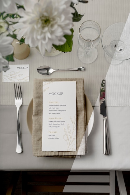 top view of spring menu mock-up on plate with cutlery and glasses