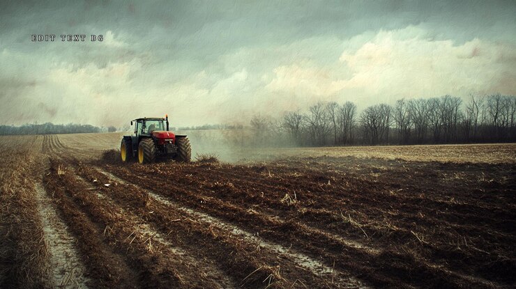 PSD tractor plowing a field under a dramatic sky