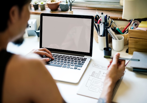 Um homem está trabalhando com laptop