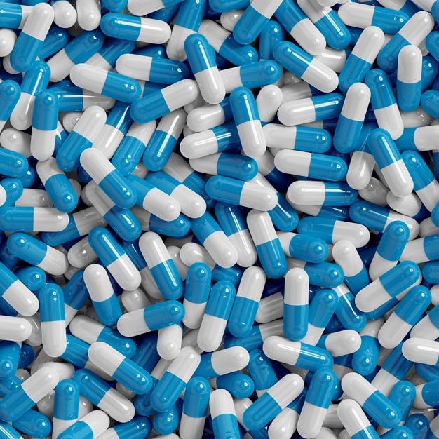 uma pilha de pílulas azuis e brancas que dizem pílulas