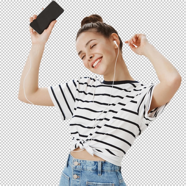 Uma rapariga caucasiana despreocupada a dançar com fones de ouvido e smartphone.