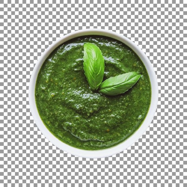 Una ciotola di pesto verde con sopra delle foglie di basilico
