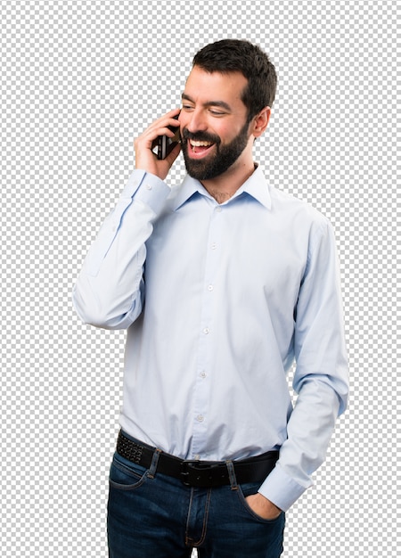 Uomo bello felice con la barba che comunica con mobile