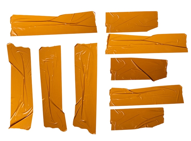 PSD various pieces of orange tape on a white background