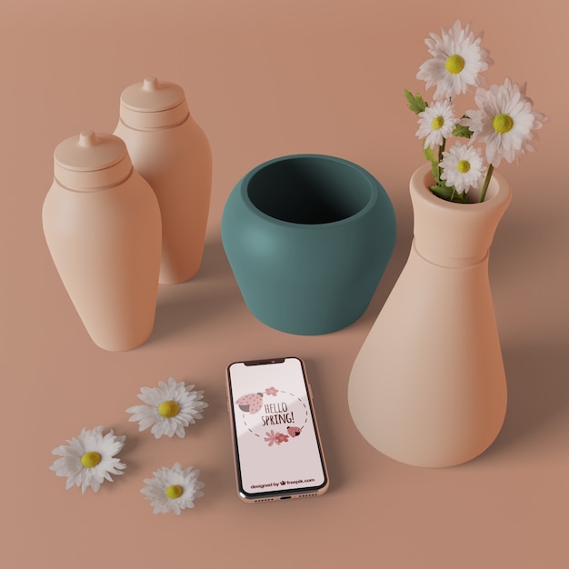 PSD vases 3d avec des fleurs à côté du téléphone