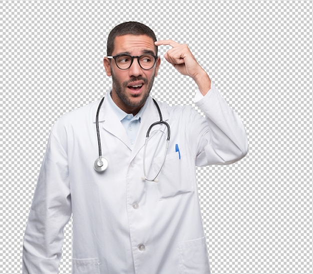Verwirrter junger Doktor, der eine Geste der Verwirrung tut