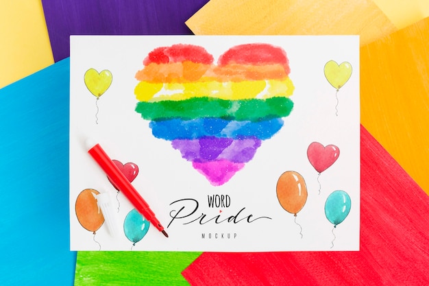 Vista dall'alto del cuore colorato arcobaleno su carta con palloncini per orgoglio lgbt