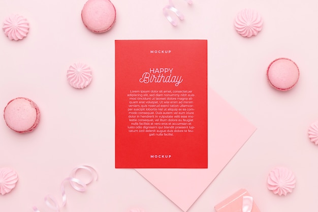 Vista dall'alto del mock-up di invito di compleanno con macarons