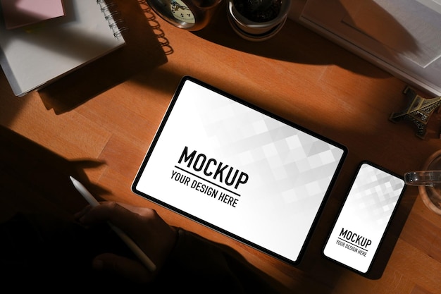 Vista dall'alto dell'area di lavoro con tablet digitale e mockup di smartphone