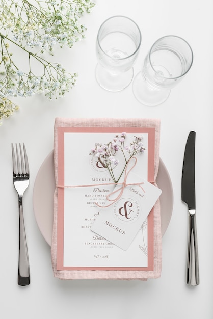Vista dall'alto della disposizione dei tavoli con mock-up di menu primaverile e posate